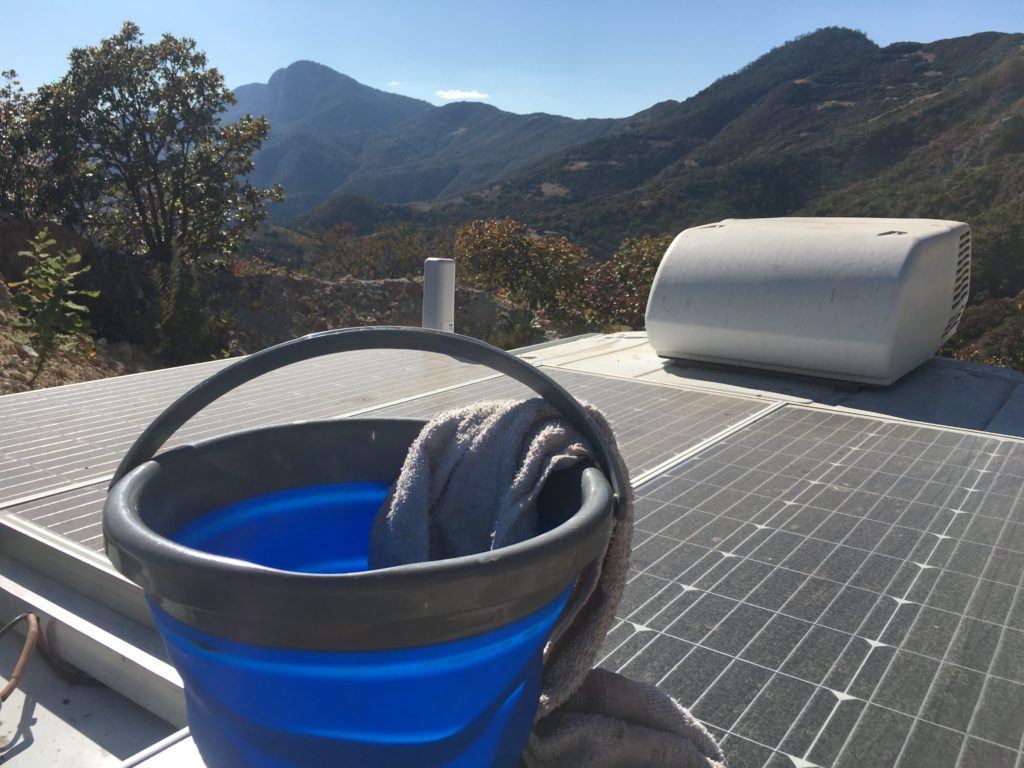 bucket with rag on solar panels