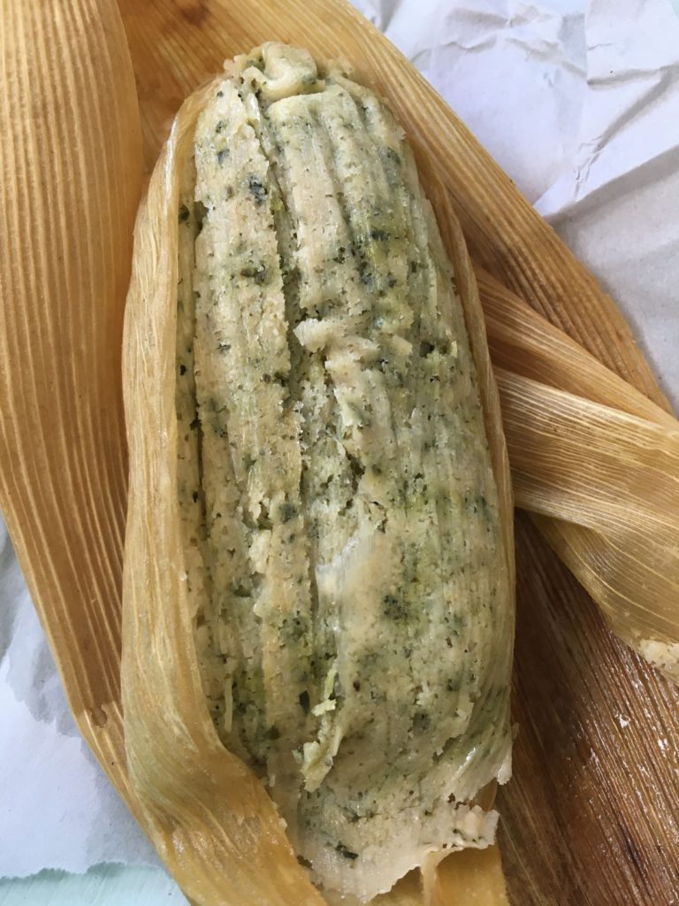 unwrapped tamale on corn husk