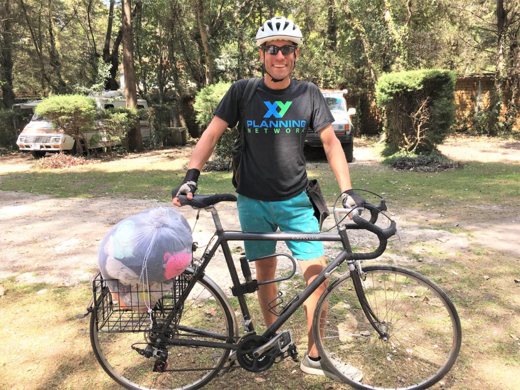 man standing next to bicycle